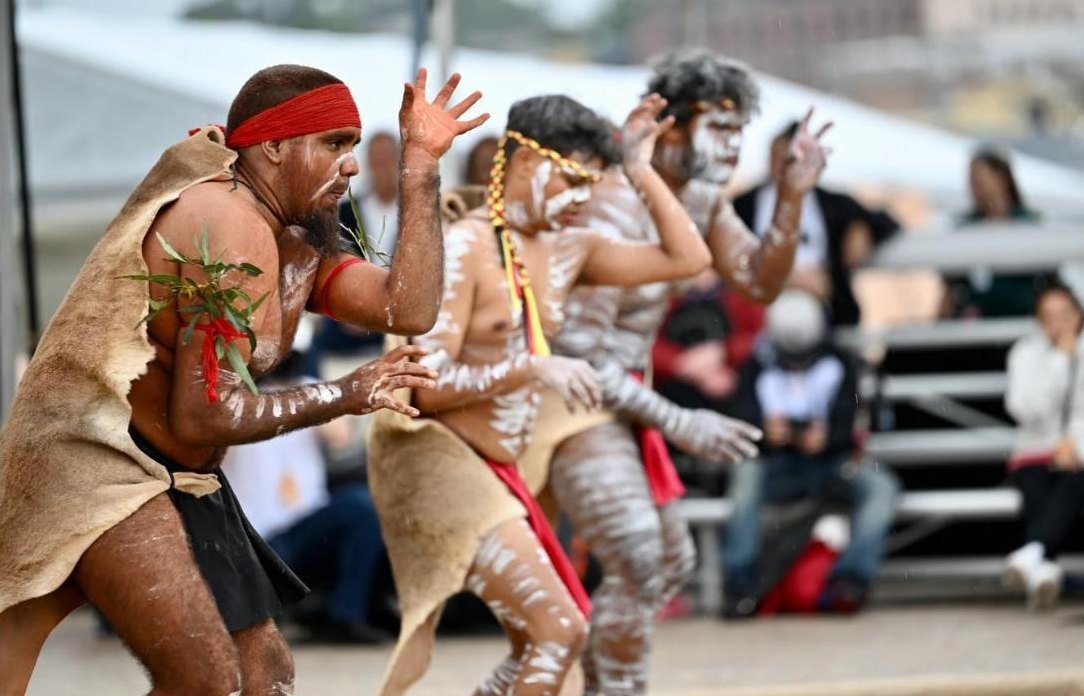 Ngadju dancers in body paint performing in front of a crowd